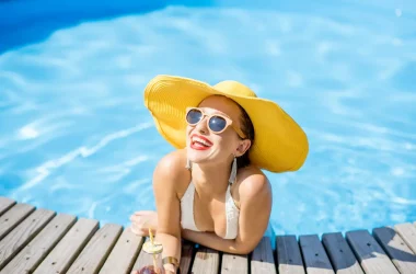 Cabelos Saudáveis 8 Dicas de Cuidados Nesse Verão - Mulher sorrindo na beira da piscina