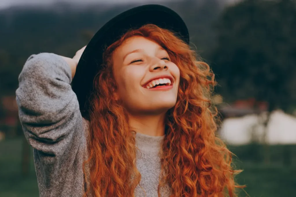 Mulher com cabelos ruivos sorrindo